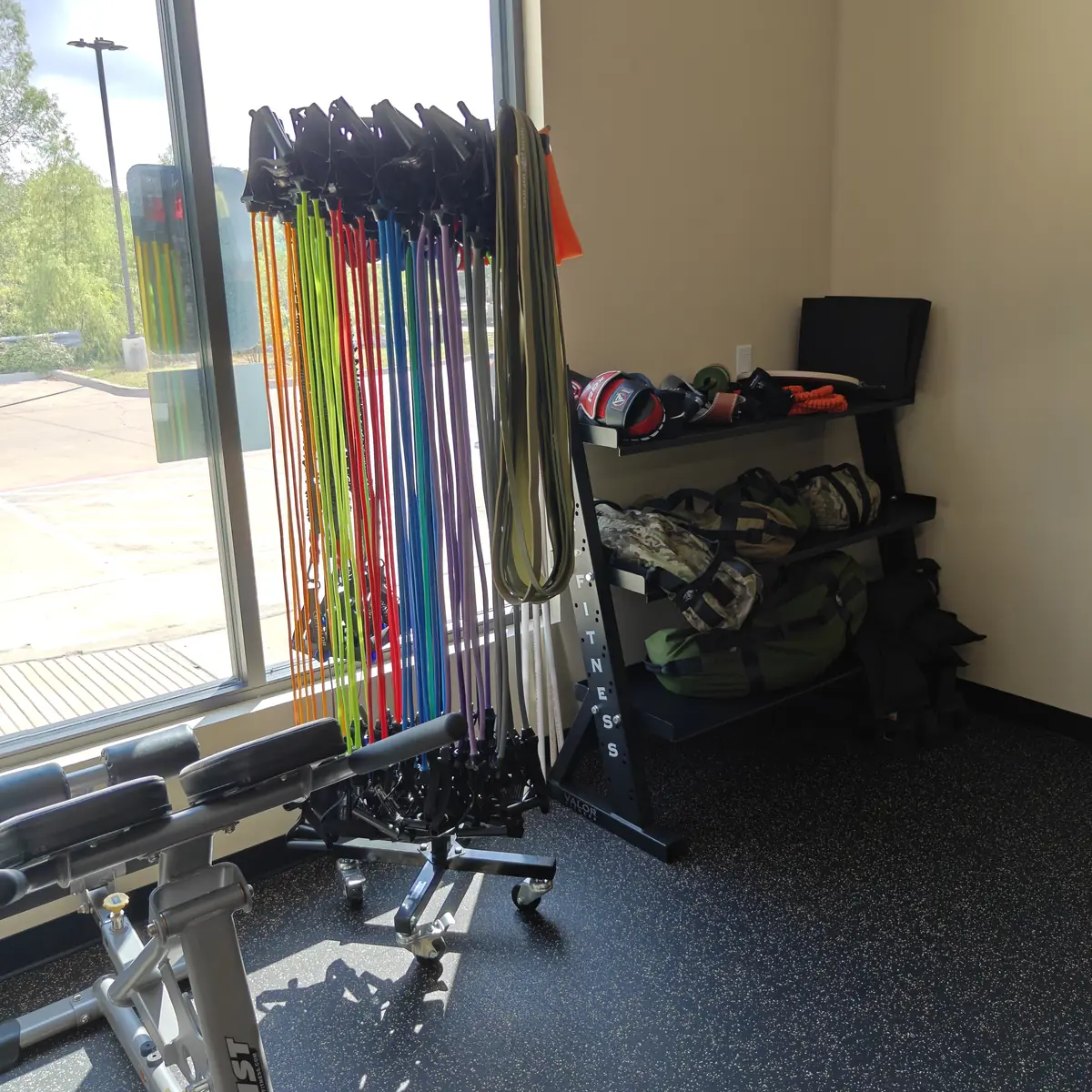 Resistance band rack and accessory shelf beside the window at Waypoint Fitness