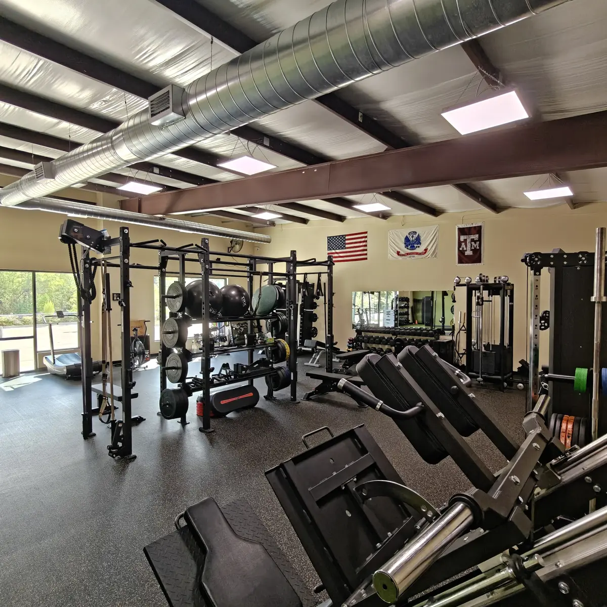 The main training floor at Waypoint Fitness, with racks, plate-loaded machines and free weights